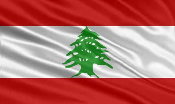 Lebanon flag design. Waving Lebanese flag made of satin or silk fabric. Vector Illustration.